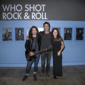 Moon Zappa, Dweezil Zappa, and Megan Marsicano posing together at a music exhibition titled 'Who Shot Rock & Roll'.