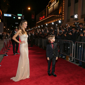 Alessandra Ambrosio and Noah Phoenix Ambrosio Mazur attending a glamorous Hollywood premiere. Red carpet bustling with paparazzi.