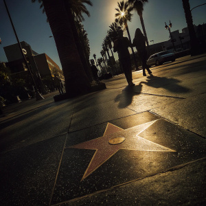 A photo of the Michael Jackson star on the Hollywood Walk of Fame. Bright sunlit day, concrete sidewalk with pedestrians in the background.
