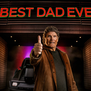 David Hasselhoff in a scene from Knight Rider, giving a thumbs-up in front of a sleek, futuristic backdrop. The setting is vibrant with a purple hue, and a bold red text reads 'BEST DAD EVER'.