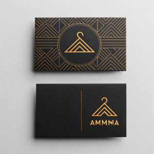 Amma clothing line's business cards. Modern, minimalist design with black as the primary color. Abstract pattern on top card, brand name 'Ammin2' on bottom. Clean lines and bold graphic logo.