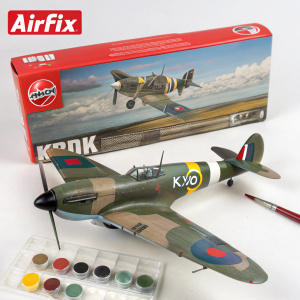 Hawker Hurricane Mk.I model kit, featuring camouflage pattern and 'KW02' marking. Includes paints, brush, and cement. Red package with flying model image and Airfix branding