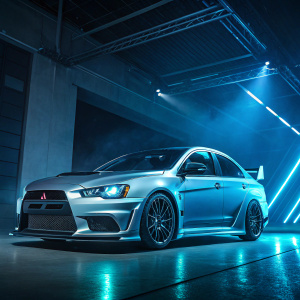 A sleek Mitsubishi EVO X concept car. Glowing in blue and silver hues under dramatic lighting. High-tech backdrop