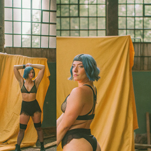 Strong female character with short blue hair. Poses in various angles. Green studio backdrop.