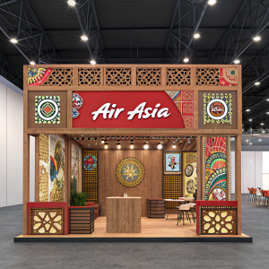 Exhibition booth for Air Asia. Vibrant tribal-inspired design with wooden elements and traditional Asian art patterns. Brand name prominently displayed in center with decorative details.