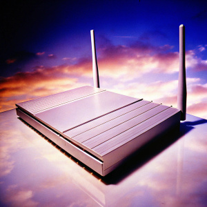 NightHawk AX12 router, sleek silver design by Enlisted Design. Modern dual-panelled structure on a dark background