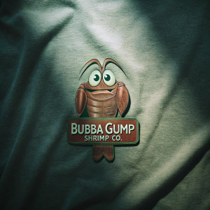 Logo for Bubba Gump Shrimp Co., playful and whimsical design with cartoon shrimp. Against a subtle, fabric-textured grey backdrop.