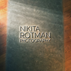 Logo for Nikita Rotman Photography. Stylish font, minimalistic design. Dark background.
