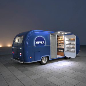 A futuristic 3D render of a promotional vehicle for Nivea. The vehicle is a sleek, metallic blue caravan with an open side door revealing an array of Nivea products. Soft, ambient lighting highlights the modern, minimalist design and branding.