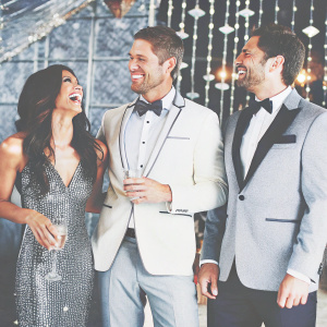 Roselyn Sanchez, Eric Winter, and Carlos Espejel laughing at a glitzy Hollywood party.