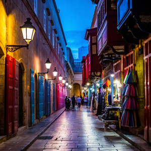 Colorful bustling market street in Mdina, Malta. Vibrant traditional Maltese buildings with stone facades, open windows, and doors. Lantern-style lighting fixtures and a cobblestone pathway.
