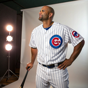 Albert Pujols, African American baseball player, in Chicago Cubs jersey, posing for a publicity shot. Studio setting with minimal background.