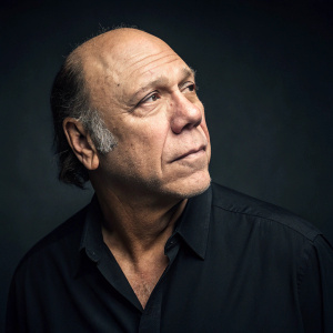 Dayton Callie, an actor, attending the Gotham Awards. Balding hairline, rugged look. Black shirt, intense expression. Dark, sleek background.