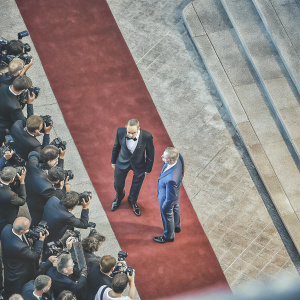 Daniel Day-Lewis and Steven Spielberg at Cannes Film Festival premiere. Day-Lewis in a classic black tuxedo. Spielberg in a blue suit. Red carpet event