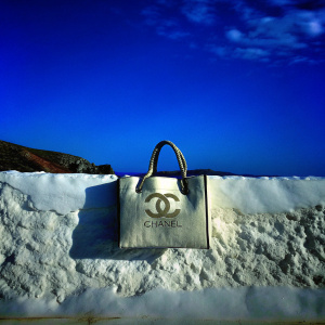 Chanel tote bag, beige fabric, rugged texture, white backdrop, interlocked 'C' logo
