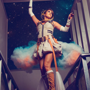 Mercy Soraka from League of Legends, wearing futuristic attire, floating amidst a cosmic nebula.