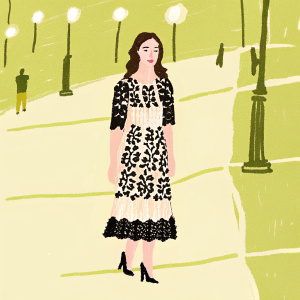 Olga Kurylenko in a stylish black and white lace dress on a bustling city street at night.