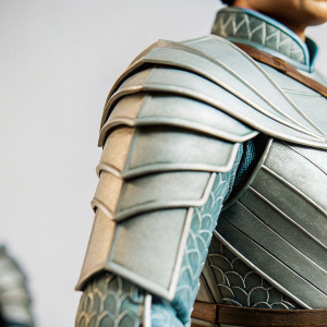 Close-up shots of Brienne of Tarth's armor, showcasing intricate gray and dark patterns. Neutral gray backdrop.