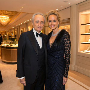 Jose Carreras and Jutta Jager, both dressed elegantly, posing inside the luxurious Chopard boutique at Hotel La Mamounia. The atmosphere is warm and inviting, with ambient lighting casting soft shadows.