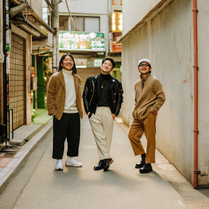Park Jung-Min, Hong Won-Chan, and Lee Jung-Jae, in casual streetwear, posing for a candid photo shoot in a bustling Seoul alleyway. Graffiti-covered walls and neon signs in the background.