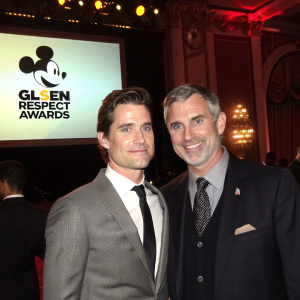 Matt Bomer and Simon Halls at the GLSEN Respect Awards, dressed in formal attire. Mickey Mouse logo prominent in background.