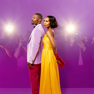 Kerry Washington and Jamie Foxx attending the Django Unchained film festival. They stand in front of a crowded auditorium with flashing cameras.