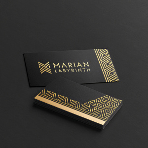 Business cards for 'Marian Labyrinth'. Sleek, minimalist design in black and gold. Modern font styles.
