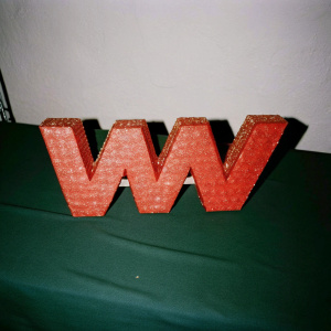 The WWE logo, featuring bold, red 'W' on a stark black backdrop.