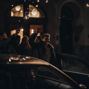 Max Verstappen, in casual attire, celebrating with fans outside a nightclub.