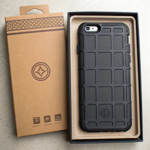 Magpul Bump Case for iPhone 6 and iPhone 6s, shown in rugged black textured grid pattern. Package in brown cardboard, featuring Magpul branding and tempered glass badge.