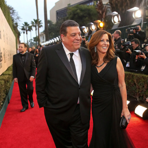 Steve Schirripa and Laura Schirripa at the Golden Globe Awards. Red carpet, flashing cameras.