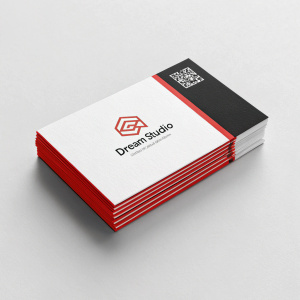 Dream Studio's promotional material. A set of sleek, minimalist business cards featuring the company logo and a QR code. Cards are in a stack, black and white with a striking red border.
