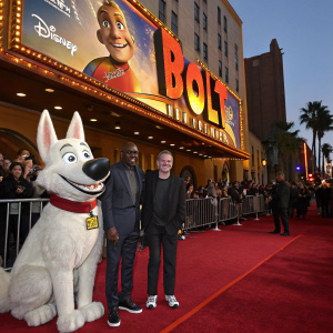 At the 'Bolt' movie premiere, animated Bolt mascot and cast members pose. The El Capitan Theatre's red carpet scene.