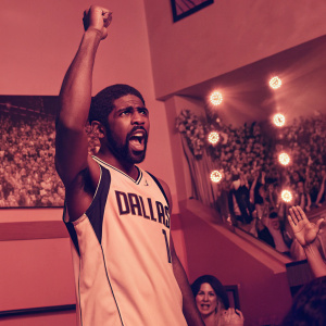 Kyrie Irving, NBA star, intense expression, Dallas Mavericks jersey. The arena filled with enthusiastic fans, colorful lights, and banners.