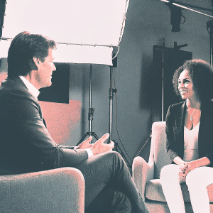 Tom Cruise and Jada Pinkett Smith in a candid scene from 'Collateral'. Studio set, blurred background.