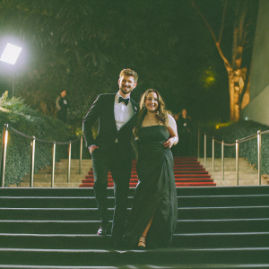 Jim Chapman and Tanya Burr on the glamorous Oscars red carpet. Both are adorned in elegant evening wear.