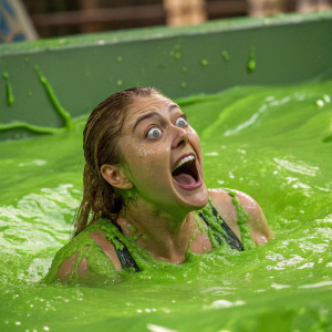 Sandy Cheeks from Bikini Bottom, floating in green goo. Her face is exaggeratedly shocked and her environment is melting around her.