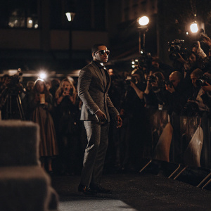 Jamie Foxx, without sunglasses, at the premiere of 'Django Unchained'. Standing alone in the spotlight on a bustling red carpet.