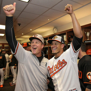 Steve Clevenger and Manny Machado, both baseball players, celebrating a victory in the locker room after a game.