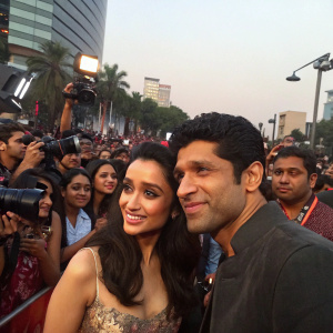 Shraddha Kapoor and Farhan Akhtar attending the premiere of their movie Rock On 2. Crowded outdoor event with fans and media