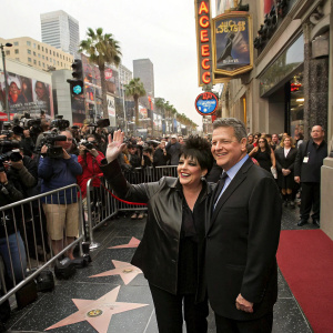 Liza Minnelli and Billy Stritch at the Hollywood Walk of Fame unveiling. Crowded street with flashing cameras and excited fans.