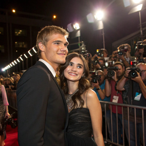 Chris Zylka and Hanna Beth Merjos at a bustling awards ceremony, surrounded by a sea of photographers and fans.
