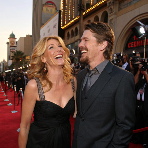 Natasha Richardson and Ethan Hawke laughing at a Hollywood film premiere. Star-studded red carpet backdrop