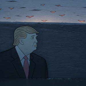 Donald Trump, in a cartoon style, with blond hair and recognizable facial features. White, bird-like shapes in a peach-colored backdrop.