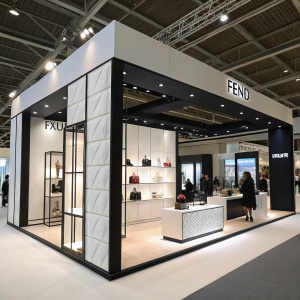 Fendi's booth at the luxury goods exhibition. Modern design with sleek black and white elements.