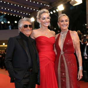 Roberto Cavalli, Eva Cavalli, and Sharon Stone posing together at the Cannes Film Festival.