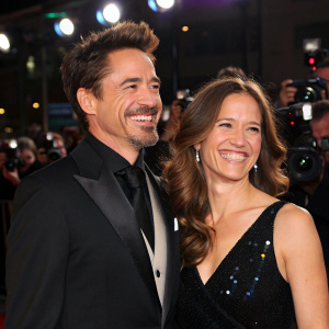 Robert Downey Jr and Deborah Falconer at the premiere event. Both dressed elegantly in formal attire. Smiling brightly for the paparazzi.