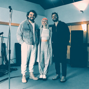 Taylor York, Hayley Williams, and Jeremy Davis from Paramore. Recording session at SiriusXM Studios. Casual outfits, smiling
