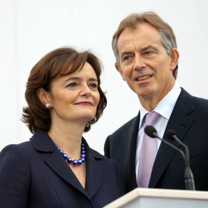 Tony Blair and Cherie Blair at a press conference. Solid white background