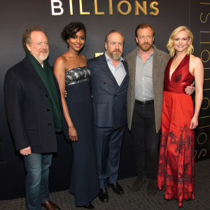 At the 'Billions' season premiere, David Costabile, Condola Rashad, Paul Giamatti, Malin Akerman, Damian Lewis, and Maggie Siff pose together. Dark hallway backdrop with 'Billions' logo